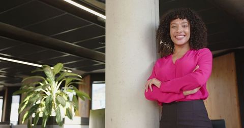 Confident professional woman in modern open-plan office