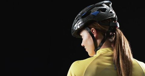 Female Cyclist Wearing Helmet Ready for Night Ride