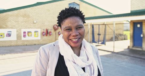 African school teacher smiling in elementary playground