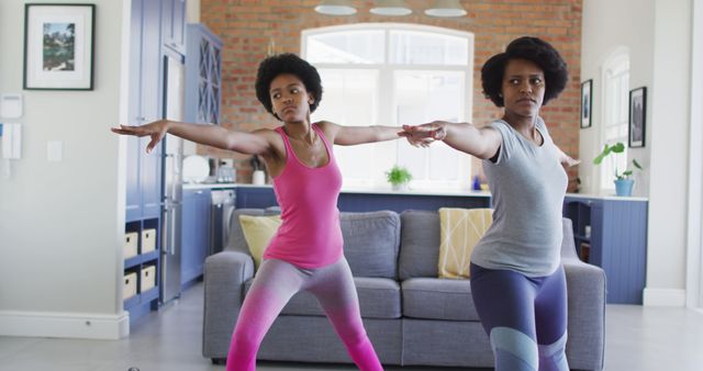 Mother and Daughter Practicing Yoga in Living Room - Download Free Stock Images Pikwizard.com