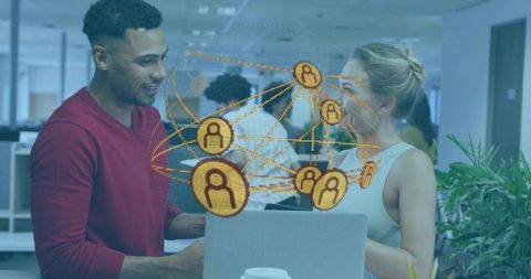 Colleagues discussing over laptop with glowing network overlay representing team connectivity