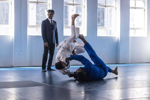 Martial Arts Fighters Demonstrating Grappling Moves in Gym