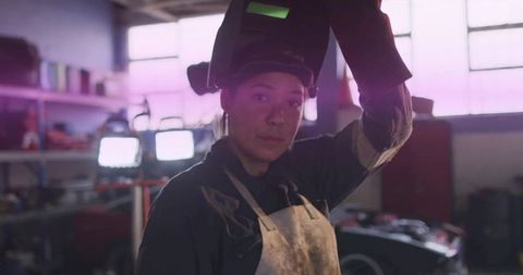 Female welder conducting equipment check in workshop