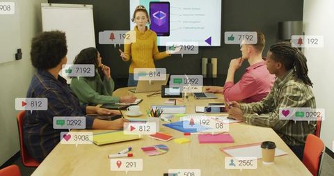 Presenter in mustard sweater leading team briefing with social icons overlays