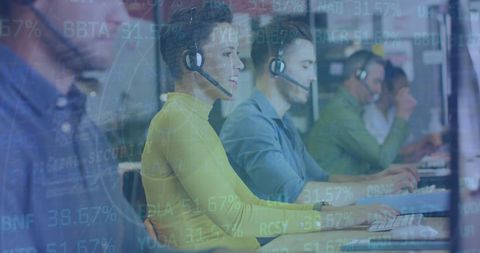 Diverse team in office headsets analyzing financial data
