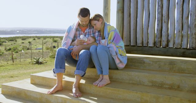 Young Family Bonding While Feeding Baby Outdoors - Download Free Stock Images Pikwizard.com