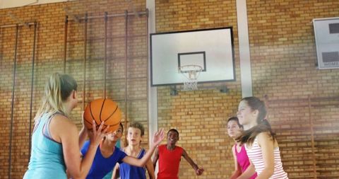 Youth basketball training in school gym
