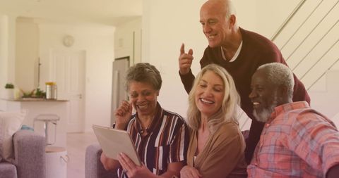 Seniors Engaging with Digital Tablet in Social Setting