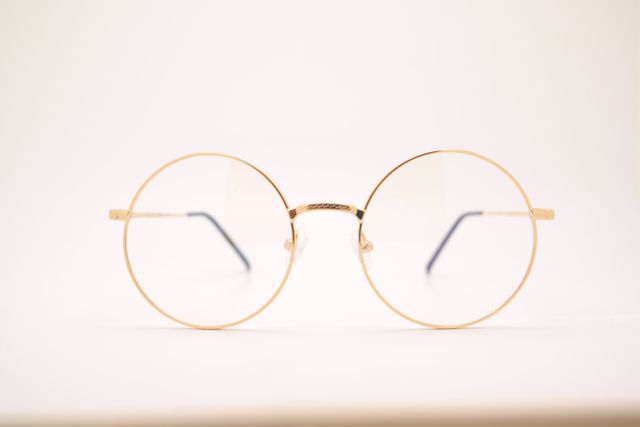 Minimalist Gold Round Glasses Against White Background - Download Free Stock Photos Pikwizard.com