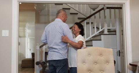 Smiling Senior Couple Embracing in Relaxed Home Environment