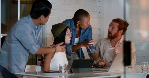 Diverse Team Collaborating on Project with Technology in Modern Office