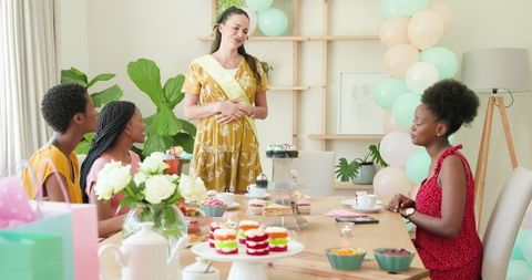 Diverse Friends Celebrating with Laughter at Home Tea Party