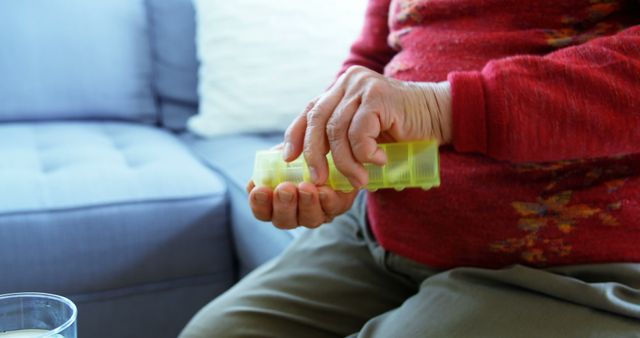 Elderly Person Taking Daily Medication from Pill Organizer at Home - Download Free Stock Images Pikwizard.com