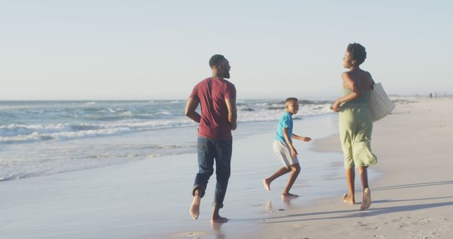 Happy Family Running and Playing Together on Sandy Beach - Download Free Stock Images Pikwizard.com