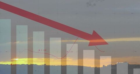Sunset skyline with red downward arrow signaling economic downturn and falling chart trend