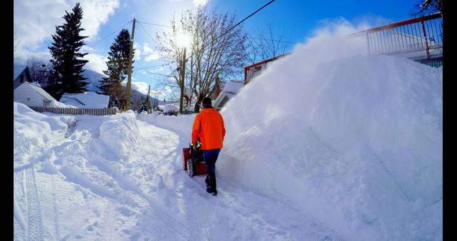 Person clearing snow-covered street with snow blower on a sunny winter day - Download Free Stock Images Pikwizard.com