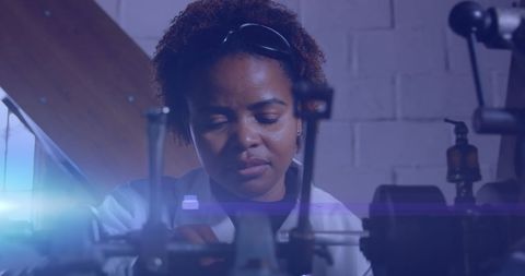 African American Woman Working in Industrial Workshop with Futuristic Glow - Download Free Stock Images Pikwizard.com
