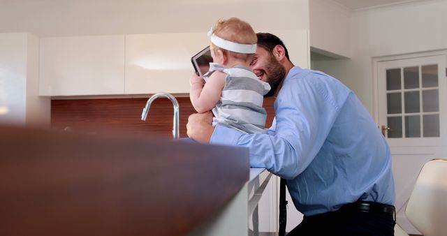 Father Playing with Baby in Modern Kitchen - Download Free Stock Images Pikwizard.com