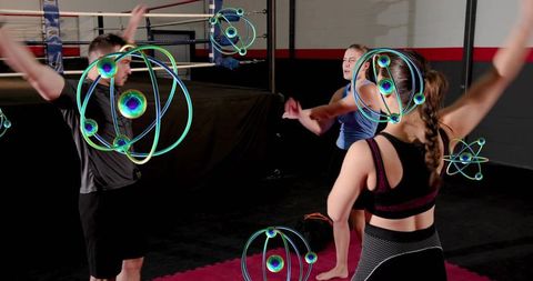Group boxing workout training team raising arms with neon energy orbs for futuristic gym