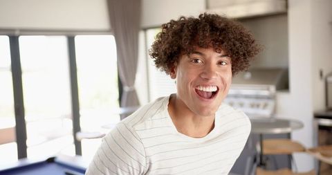 Smiling Young Man Enjoying Time at Home Kitchen in Slow Motion
