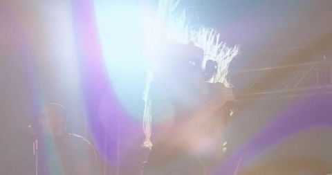 Energetic female vocalist performing on vibrant stage