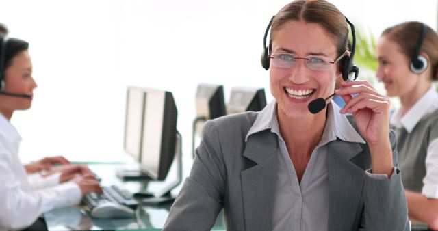 Smiling Female Call Center Representative with Headset Assisting Customers - Download Free Stock Images Pikwizard.com