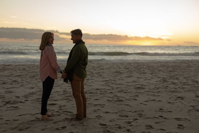 Romantic Senior Couple Holding Hands on Sunset Beach - Download Free Stock Photos Pikwizard.com