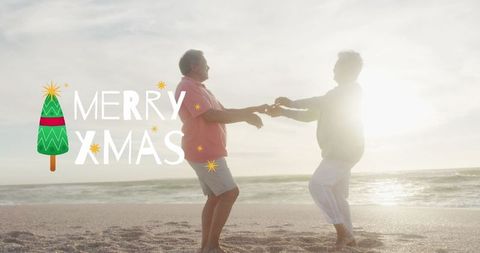 Joyful Senior Couple Dancing on Beach at Sunset Celebrating Christmas