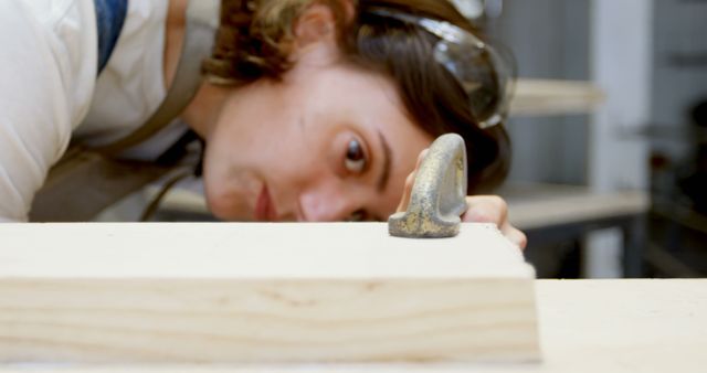 Focused Carpenter Measuring Accuracy of Wooden Plank - Download Free Stock Images Pikwizard.com