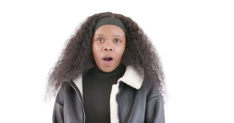 Surprised woman expressing shock with natural curly hair