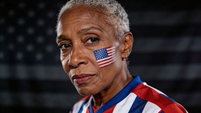 Senior woman wearing stars and stripes jersey showing american flag face paint