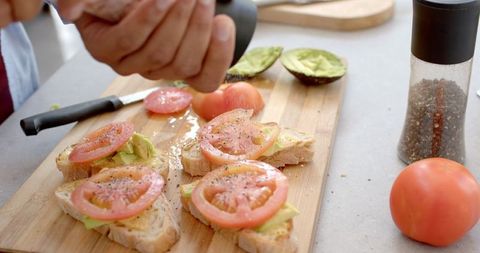 Gourmet Avocado Tomato Toast Being Seasoned with Pink Salt - Download Free Stock Images Pikwizard.com
