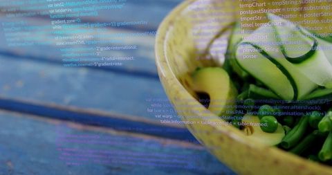 Presenting cucumber ribbons and olives in ceramic bowl with code overlay on rustic blue wood