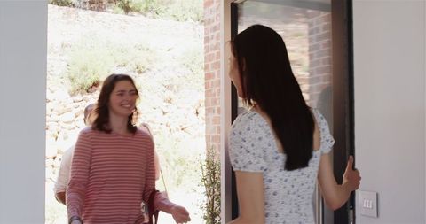 Diverse Friends Arriving Excitedly at Housewarming Party
