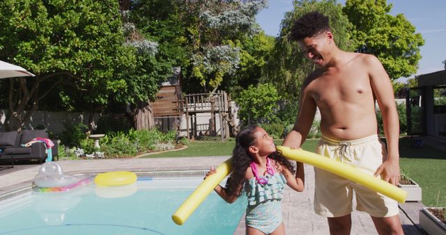 Happy biracial father and daughter spending time at pool together. domestic lifestyle, spending free time at home.