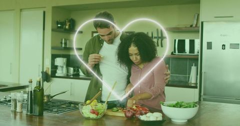 Happy Couple Cooking Vegetarian Meal With Heart, Romance in Kitchen