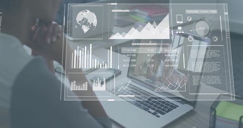 Professional Analyzing Holographic Data Dashboard Projecting Over Laptop in Team Workspace