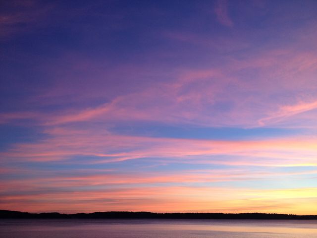 Serene Sunset with Vibrant Sky Over Calm Waters - Download Free Stock Photos Pikwizard.com