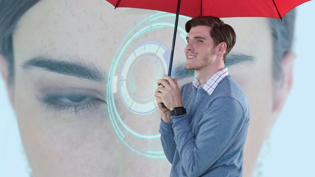 Young Caucasian man holding a red umbrella and smiling, against a blue background featuring a futuristic digital interface focused on a woman's eyes. Ideal for tech promotional materials, digital interface demonstrations, facial recognition technology showcases, and futuristic concept advertisements.