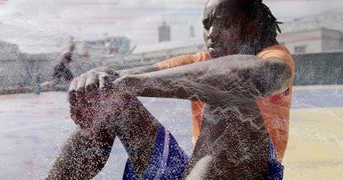 Male Athlete Resting on Urban Rooftop Basketball Court