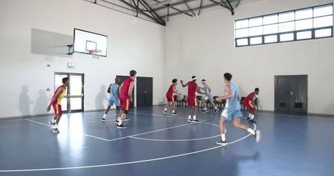Intense Basketball Game in Indoor Gym with Enthusiastic Players