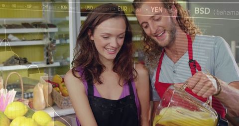 Pouring fresh juice at farmers market counter, smiling vendors with pitcher