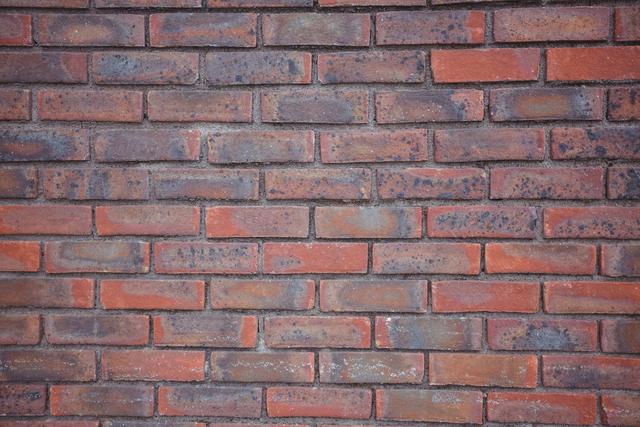 Modern brick wall background featuring red bricks with a rustic texture. Ideal for use in architectural designs, construction projects, and urban-themed presentations. Perfect for backgrounds, wallpapers, and design elements in various creative projects.