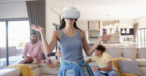 Woman Enjoying VR Experience with Friends in Modern Living Room