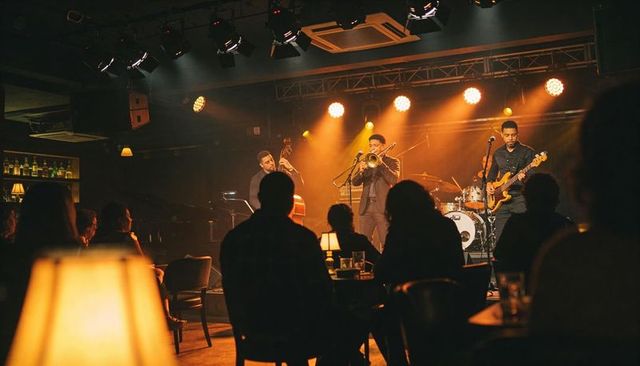 Performing jazz quartet in intimate amber-lit club with trumpet, double bass and drums
