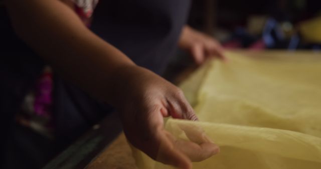 Close-up of Hand Crafting with Yellow Fabric in Workshop - Download Free Stock Images Pikwizard.com