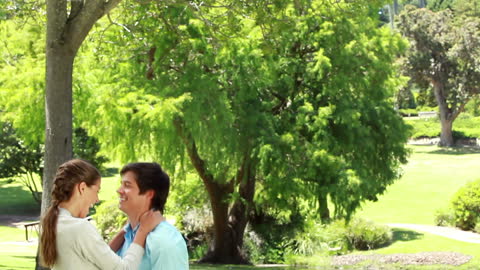 Couple Enjoying Sunny Day in Vibrant Park