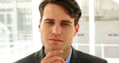 Businessman Thinking in Bright Office Environment