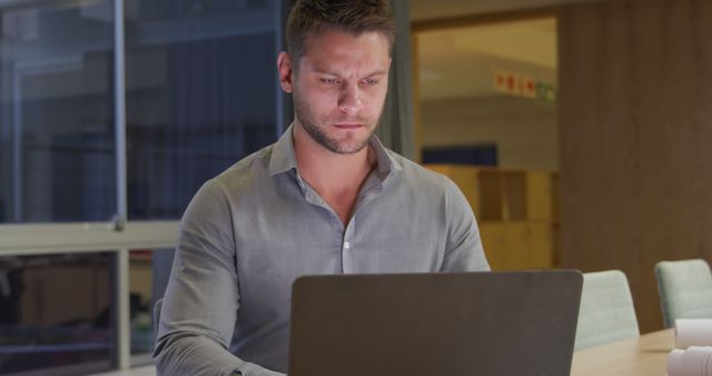 Focused Businessman Working on Laptop in Modern Office Late at Night - Download Free Stock Images Pikwizard.com