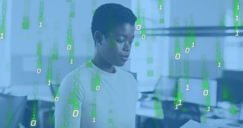 Reading data report with green binary overlay in modern open-plan office for corporate analytics